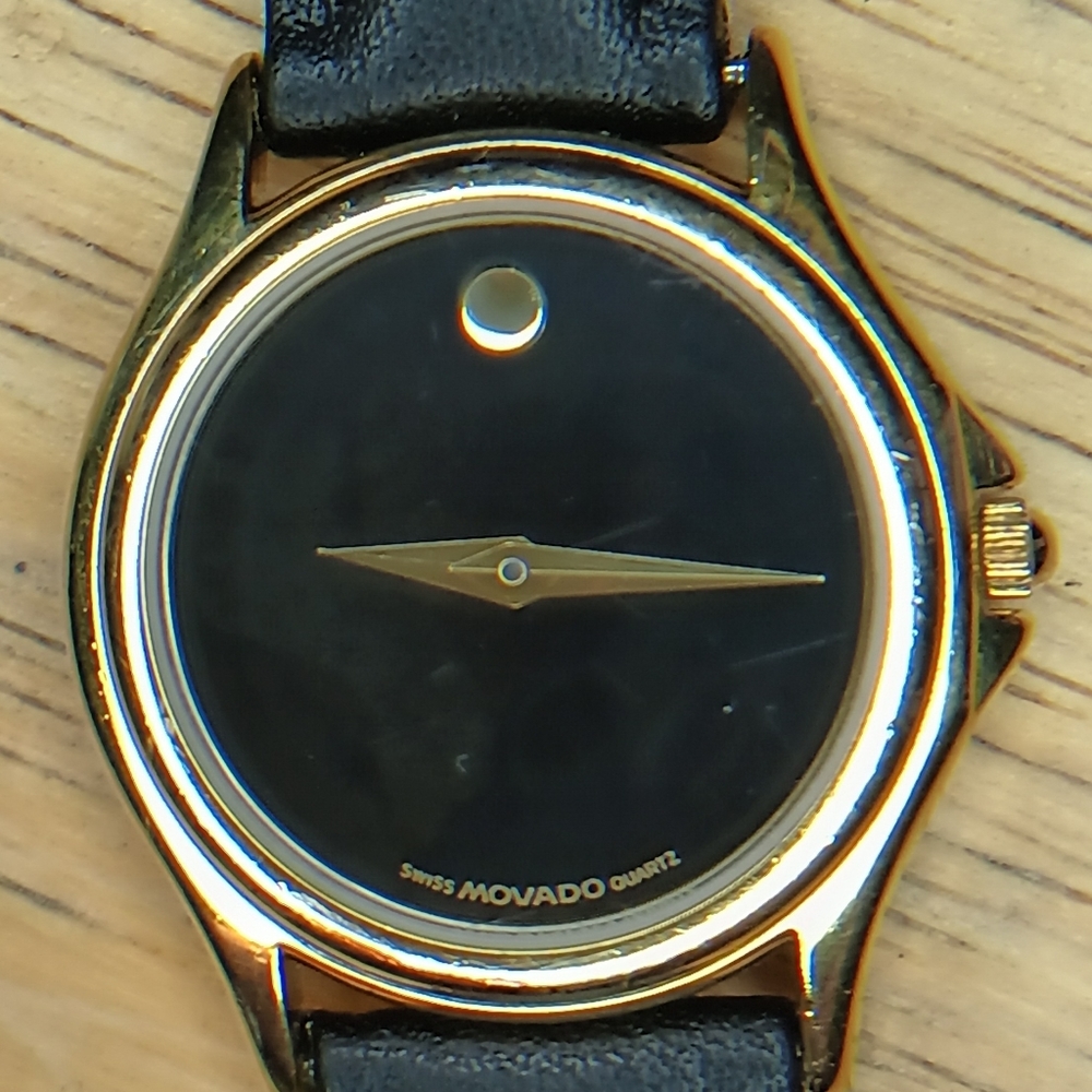 X Movado Museum Ladies. Classic gold tone case, black face, gold hands, blac